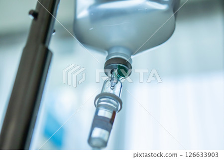 Close up medical intravenous IV drip in hospital background 126633903