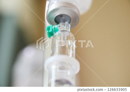 Close up medical intravenous IV drip in hospital background Close up medical intravenous IV drip in hospital background 126633905