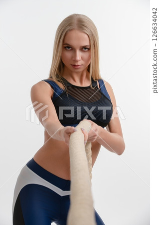 Woman demonstrating strength training in a studio setting 126634042