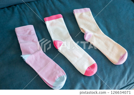 Colorful cotton sport socks on blue sofa background Colorful cotton sport socks on blue sofa background 126634071