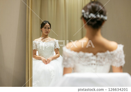 Bride getting ready in the waiting room on her wedding day 126634201