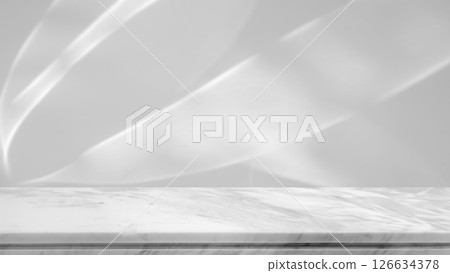 Marble table top with abstract shadow drop on white wall background for mockup product display 126634378