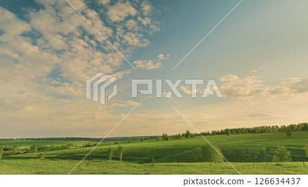 A Breathtaking Scenic Green Landscape Stretching Out Under a Beautiful Cloudy Sky Above Time lapse. 126634437