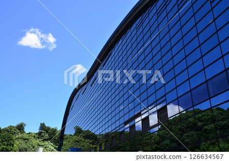 A glass building that stands out against the blue summer sky 126634567