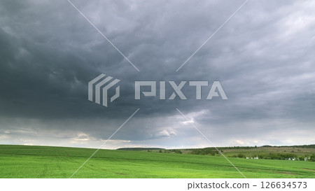 A Dramatic Sky Casts Its Enchanting Beauty Over Green Fields and Serene Landscapes Time lapse. A Dramatic Sky Casts Its Enchanting Beauty Over Green Fields and Serene Landscapes Time lapse. 126634573