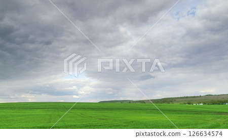 A Serene Green Landscape Awaits Beneath Overcast Cloudy Skies, Perfect for Hiking Time lapse. 126634574