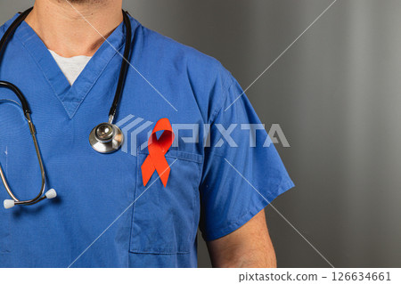 Healthcare worker in scrubs with red health awareness ribbon 126634661