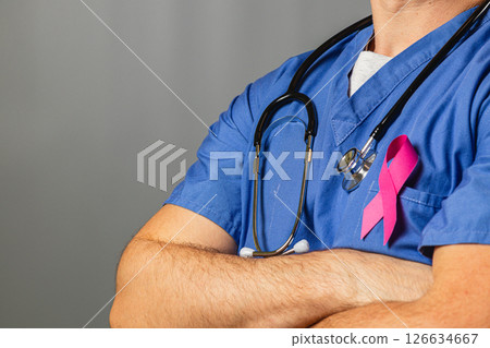 Medical professional supports cancer awareness with pink ribbon 126634667