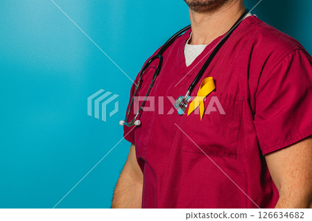 Medical professional wearing scrubs with a yellow ribbon on display 126634682