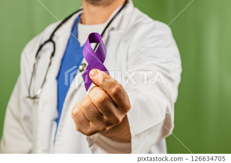 Doctor holding a purple ribbon in support of cancer awareness initiative Doctor holding a purple ribbon in support of cancer awareness initiative 126634705