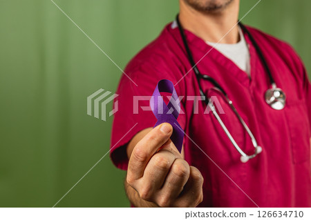 Medical professional holds purple ribbon for awareness campaign in clinic 126634710