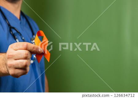 Medical professional holds an orange ribbon symbolizing awareness and support 126634712