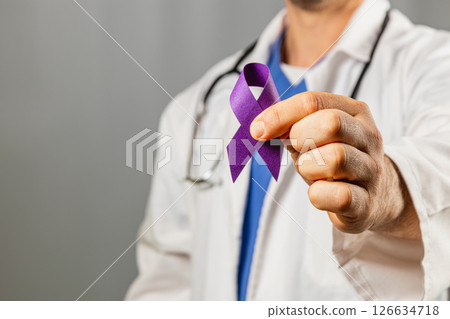 Healthcare professional holding a purple ribbon in support of awareness 126634718