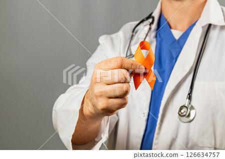 Med professional with orange ribbon for health awareness 126634757