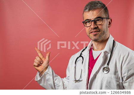 Doctor in a white coat giving a thumbs up in a clinic setting 126634986