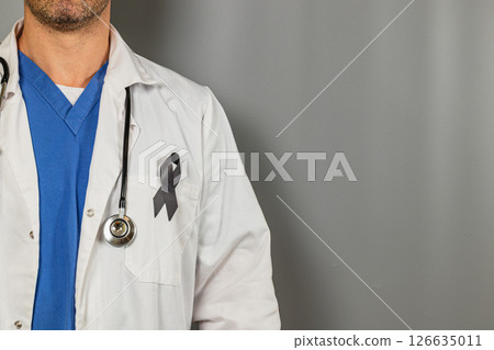 Healthcare worker wearing a black ribbon in support of health awareness Healthcare worker wearing a black ribbon in support of health awareness 126635011