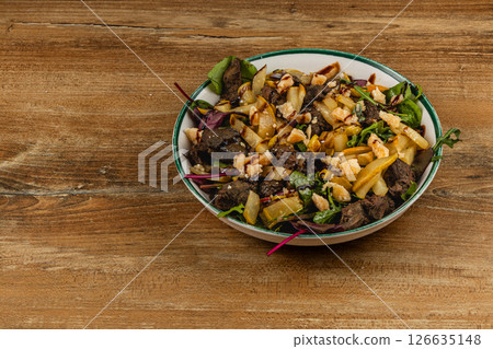 Savory mixed salad with grilled meat and nuts in bowl 126635148