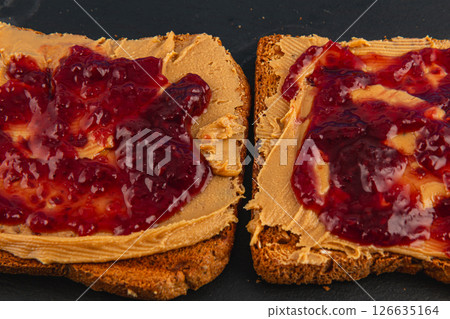 Peanut butter and jelly sandwiches on whole grain toast 126635164