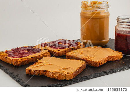 Peanut butter and jelly sandwiches prepared on a slate board 126635170