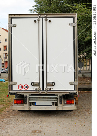 Back of closed lorry door on urban street 126635992
