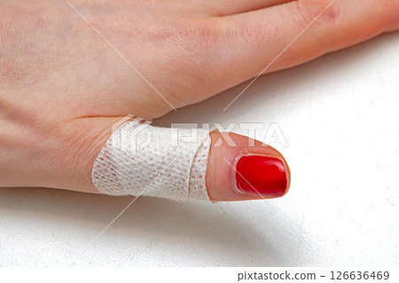 Plaster band aid on human finger 126636469