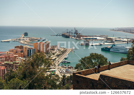 Coastal cityscape with bustling harbor under a sunny sky. Coastal cityscape with bustling harbor under a sunny sky. 126637672