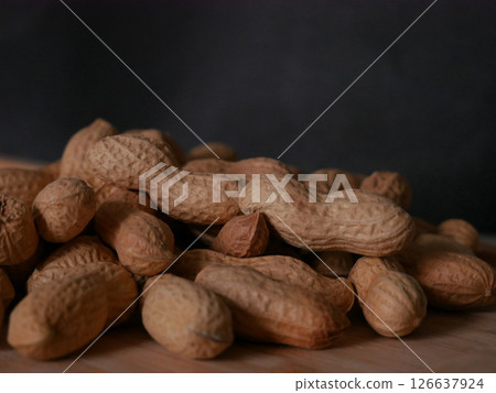 A pile of dried peanuts in shell close up. Healthy protein food 126637924