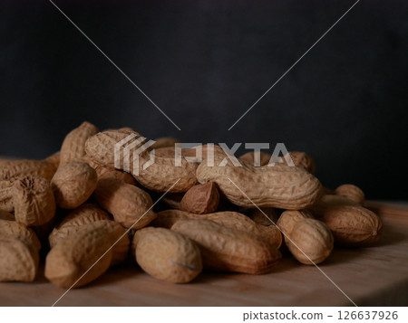 A pile of dried peanuts in shell close up. Healthy protein food 126637926