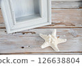 Starfish and wooden frame on a desk Summer image 1 126638804
