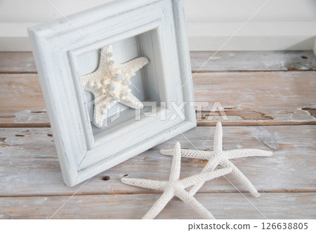 Starfish and wooden frame on a desk Summer image 2 126638805
