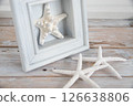 Starfish and wooden frame on a desk Summer image 3 126638806