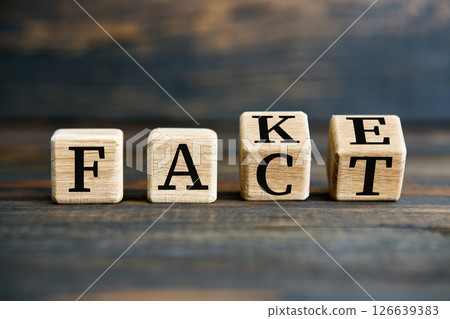 Flipping wooden cube blocks with FAKE to FACT text on wooden background Flipping wooden cube blocks with FAKE to FACT text on wooden background 126639383