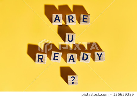 Are You Ready question on wooden blocks over bright yellow background 126639389