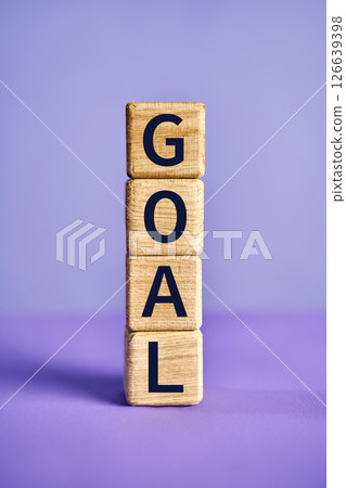 The word GOAL on wooden blocks over vibrant purple background 126639398