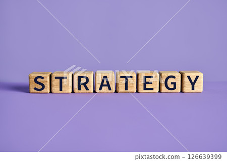 Wooden blocks spelling the word STRATEGY on purple background 126639399