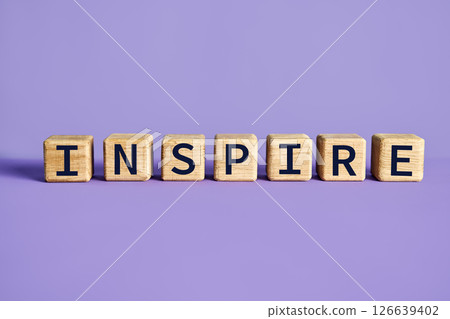 Wooden blocks spelling the word INSPIRE purple background 126639402