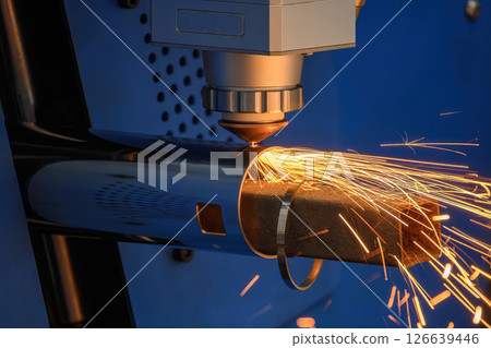 Close up scene the fiber laser cutting machine cut the stainless steel tube with sparkling light. 126639446