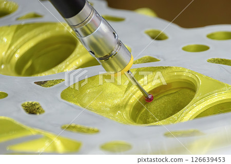 The multi-axis CMM machine measuring the aluminum cylinder head parts. 126639453