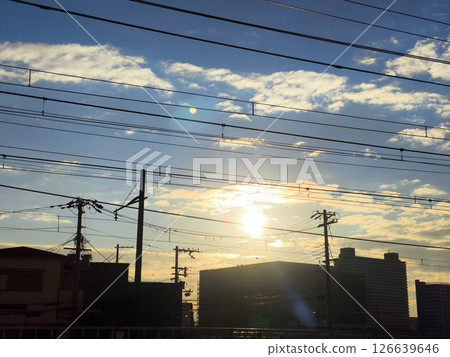 Electric wires and city silhouette at sunset 126639646