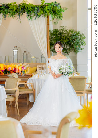Bride holding a bouquet at wedding venue 126639700