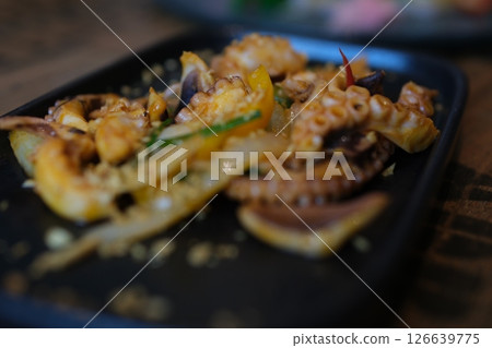 Octopus cooking, chef grill fresh octopus galician style on restaurant kitchen, healthy food, seafood cafe in spain, traditional asian japanese spanish and mediterranean dish. Octopus cooking, chef grill fresh octopus galician style on restaurant kitchen, healthy food, seafood cafe in spain, traditional asian japanese spanish and mediterranean dish. 126639775