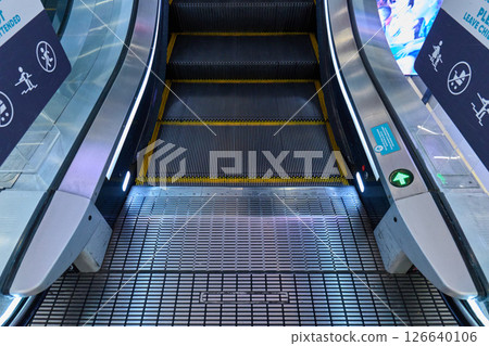 A modern escalator leads upward. High quality photo 126640106