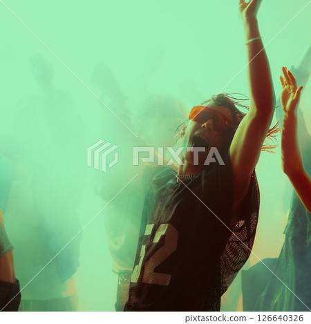 Dynamic group dance party. Vibrant lighting with people celebrating. 126640326
