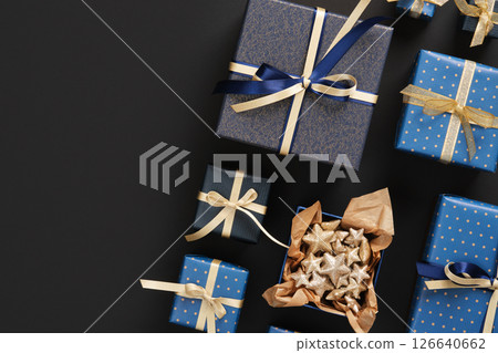 Horizontal banner with gift boxes in blue color and with golden ribbons on black background. Space for your text. Horizontal banner with gift boxes in blue color and with golden ribbons on black background. Space for your text. 126640662