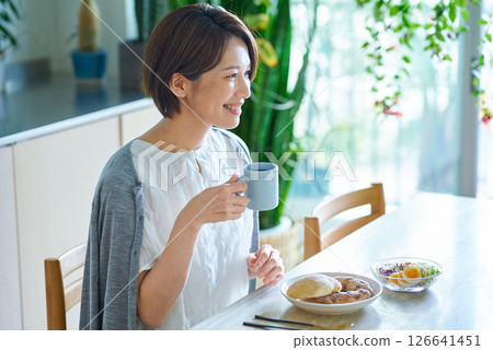 Female eating breakfast in the room Female eating breakfast in the room 126641451