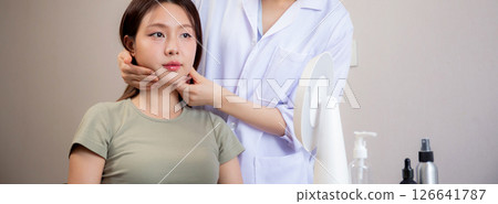 Young asian patient woman consulting with doctor in coat about wrinkle and skin for rejuvenate. Young asian patient woman consulting with doctor in coat about wrinkle and skin for rejuvenate. 126641787
