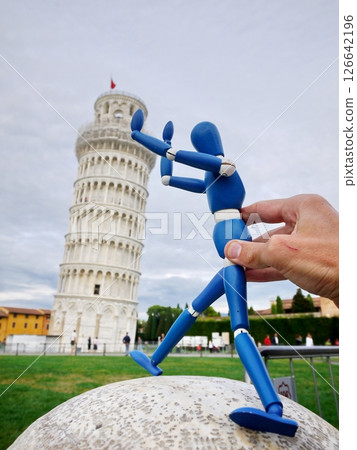 Blue figure is standing on a stone and holding another figure's hand 126642196