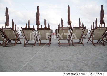 Row of beach chairs are lined up on the sand 126642262