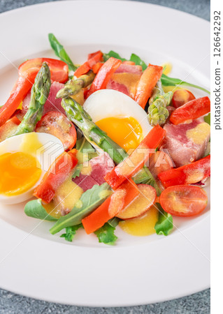 Elegant Nicoise portion with eggs, tuna, arugula, asparagus, cherry tomatoes, white plate Elegant Nicoise portion with eggs, tuna, arugula, asparagus, cherry tomatoes, white plate 126642292