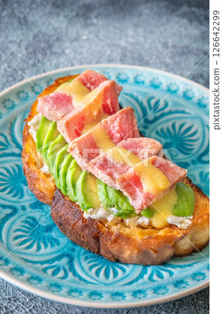 Tuna avocado sandwich with labneh and mustard-lemon sauce on toasted bread Tuna avocado sandwich with labneh and mustard-lemon sauce on toasted bread 126642299